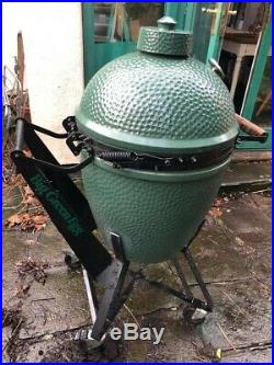 Large Big Green Egg barbeque grill with integrated nest handler
