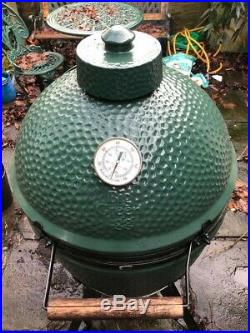Large Big Green Egg barbeque grill with integrated nest handler